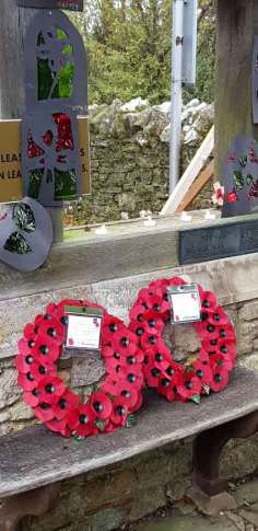 Wreaths and school children's "stained glass windows" at church gate